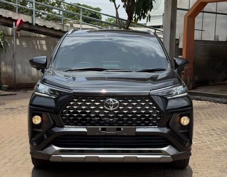Front view of a black Toyota SUV showing a prominent grille and headlights in a parking area.