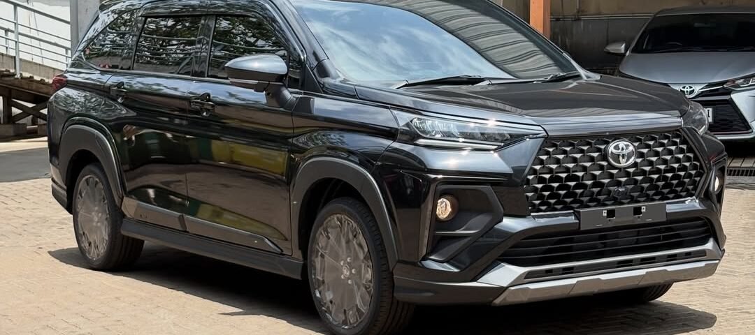Black Toyota SUV parked in a car wash area with a modern front grille and glossy finish.