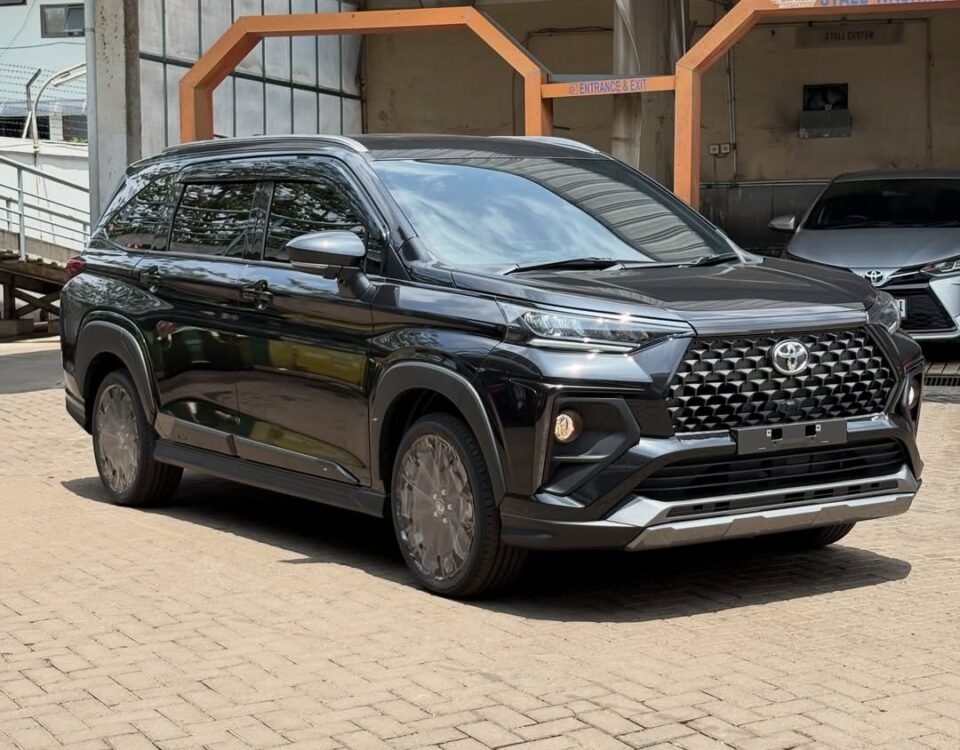Black Toyota SUV parked in a car wash area with a modern front grille and glossy finish.