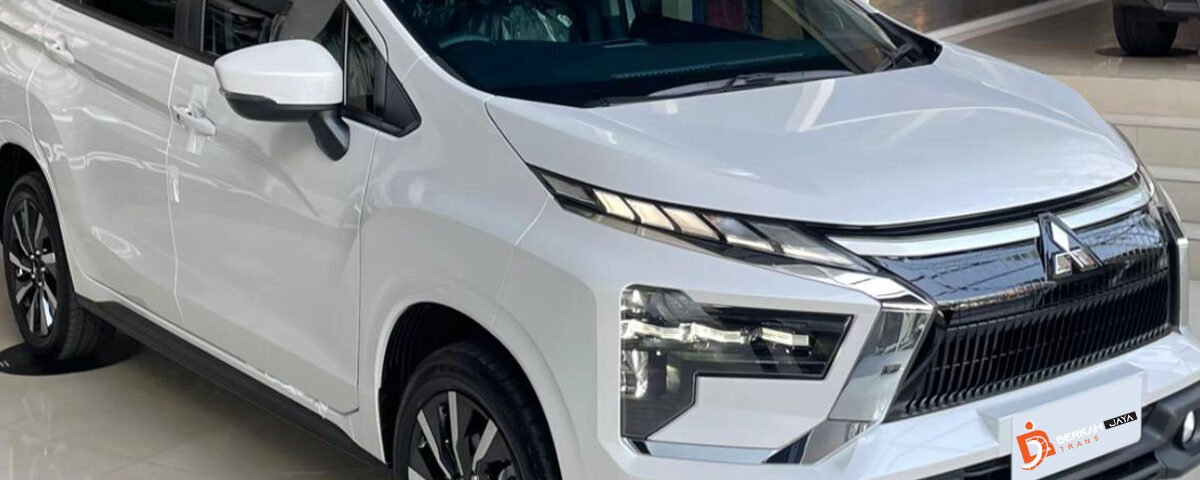 White modern SUV on a showroom floor with Berkah Jaya Trans branding on the logo mat nearby, sleek chrome grille and angled headlights visible.