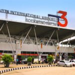 Exterior of Jakarta International Airport Terminal 3 (Soekarno–Hatta), with a large red 3 sign and cars dropping off under a glass-front façade.