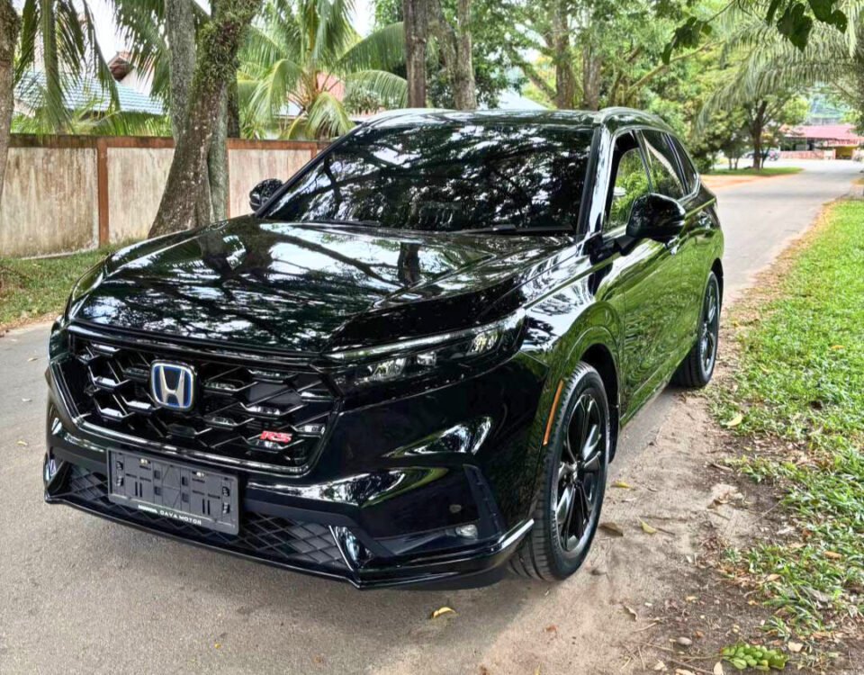 Black Honda SUV parked on a tree-lined street, glossy reflections on the hood and windows.