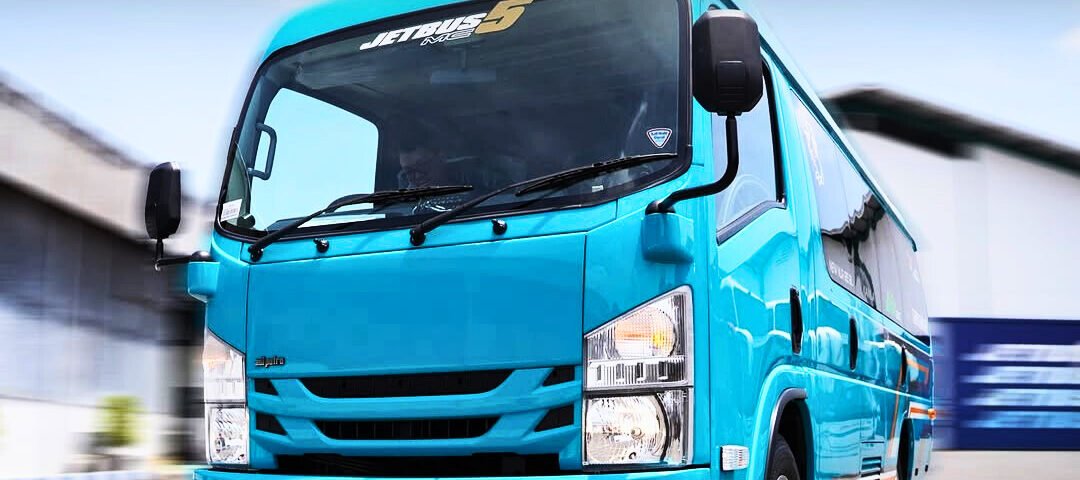 Blue delivery van driving toward the camera with DYAN TRANSPORT logo in the top-left.