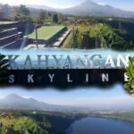 Terraced outdoor deck at Kahyangan Skyline with glass railing, greenery, and distant mountains.