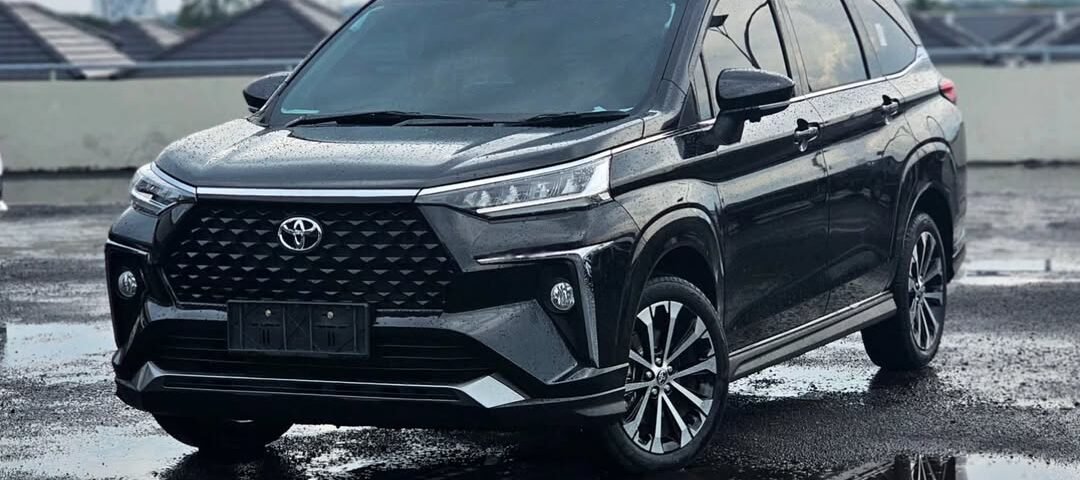 Black Toyota SUV parked on a wet rooftop with puddles and reflections nearby, rainy day scene orienting the vehicle's front-left side.