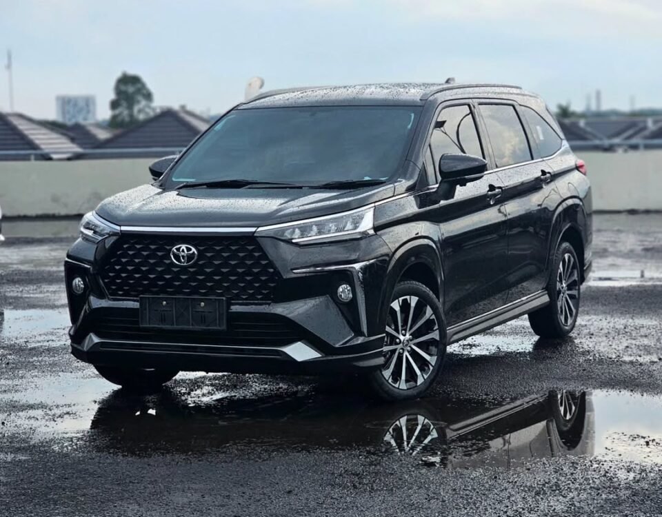 Black Toyota SUV parked on a wet rooftop with puddles and reflections nearby, rainy day scene orienting the vehicle's front-left side.
