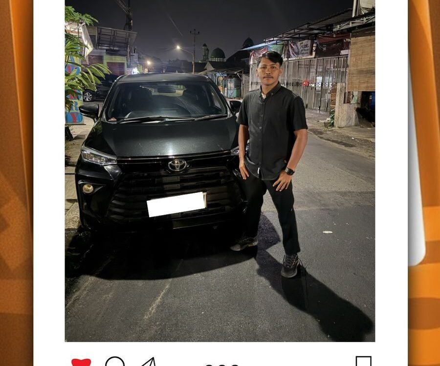 Man in a black shirt posing beside a black SUV on a nighttime city street and storefronts in the background, group photo-style post context included.