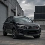 SaveTikTokto_7639733654826061076_1 - Dyantransport Front three-quarter view of a black Honda SUV parked in an industrial loading area with concrete walls and cloudy sky ahead of it.