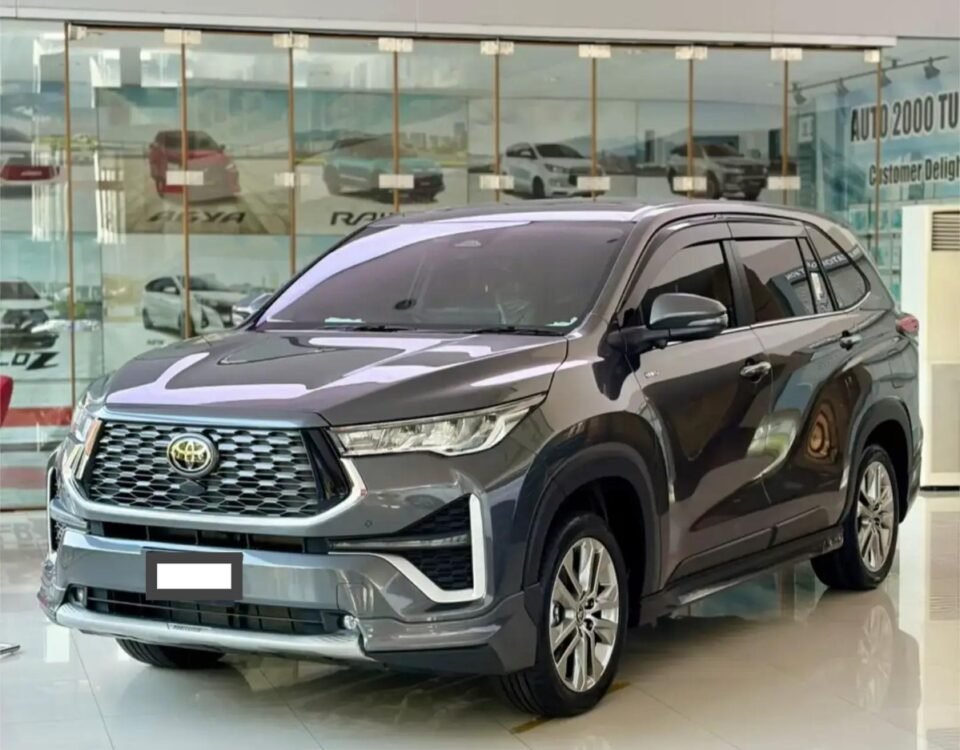 WhatsApp Image 2026-08-09 at 105239 - Dyantransport Gray Toyota SUV on a glossy showroom floor with glass walls and other cars in the background (front three-quarter view).