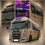 WhatsApp Image 2026-08-15 at 102916 - Dyantransport Front view of a beige Isuzu Elf Pariwisata tour bus on a blurred promotional collage background.