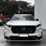 WhatsApp Image 2026-08-18 at 112020 - Dyantransport Front view of a white Honda SUV (RS trim) parked on a concrete lot, showing bold black grille and emblem.
