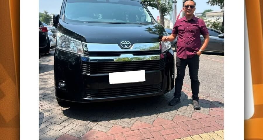 Man standing beside a black Toyota van in a parking lot; pickup service post for Semarang.
