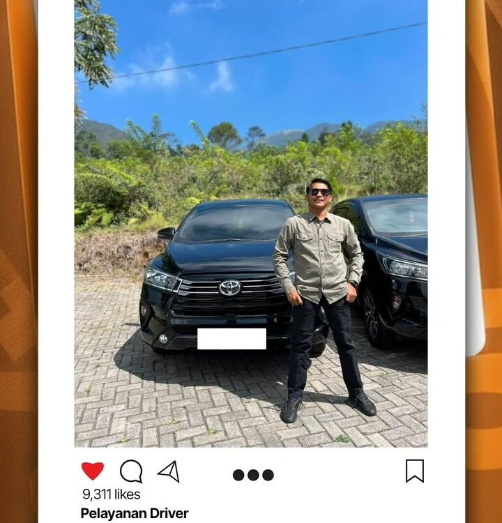Man in a beige shirt and sunglasses posing in front of two black SUVs in a sunny outdoor lot with greenery behind him from a social post image.