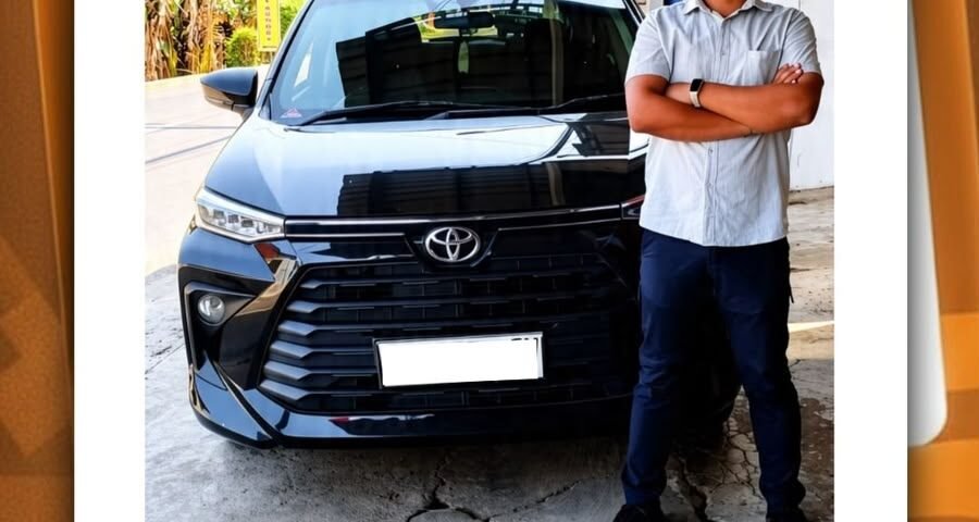Man standing with arms crossed beside a dark Toyota in a parking area; Instagram post by CV Berkah Dyntransport about driver services in Semarang (Safari Camp Family).