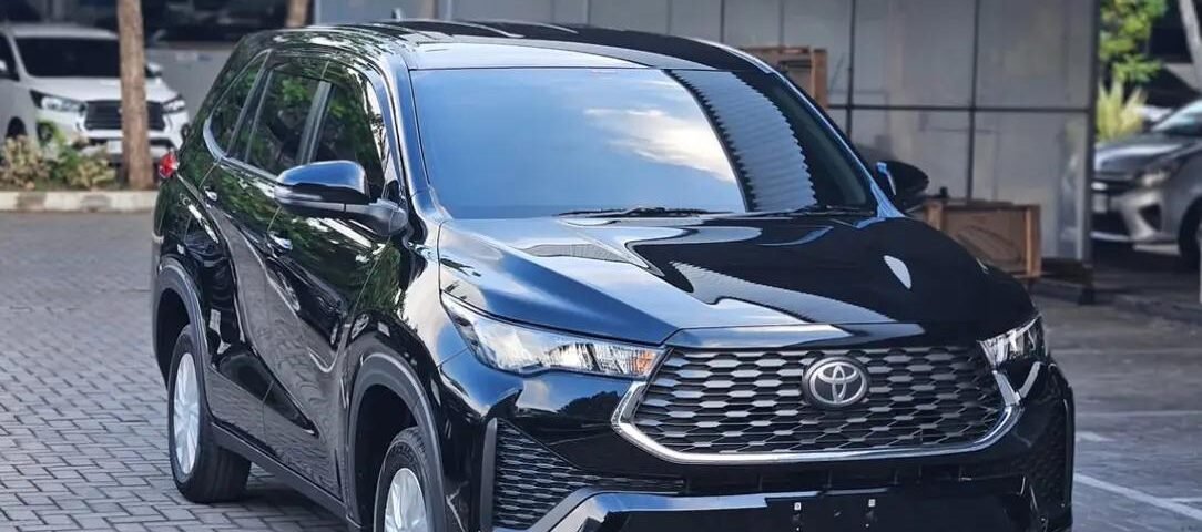 snaptik-app-7674134362589269256-slide-3 - Dyantransport Black Toyota SUV parked on a brick driveway under a metal canopy, reflecting sunlight on its polished surface.